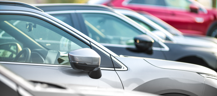 Close up side view of cars parked on a lot